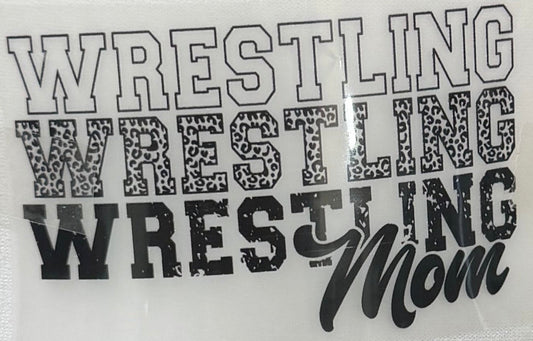 A close-up of a vinyl decal or sticker sheet featuring the text 'WRESTLING WRESTLING WRESTLING Mom' in black and gray lettering on a white background.