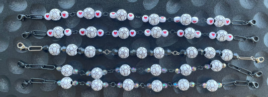 A collection of decorative hat chains with varying designs and charms, attached to lobster clasps.