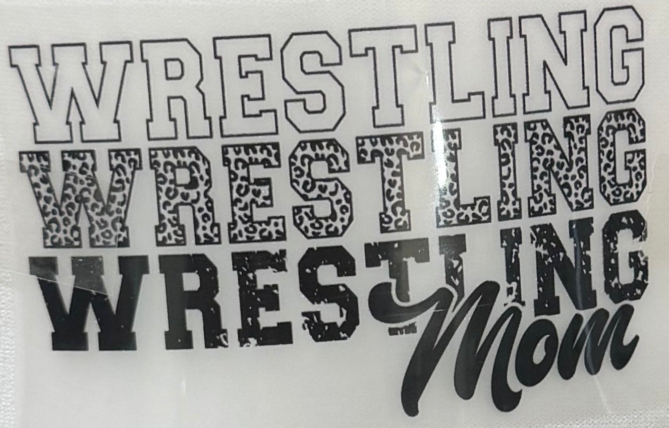 A close-up of a vinyl decal or sticker sheet featuring the text 'WRESTLING WRESTLING WRESTLING Mom' in black and gray lettering on a white background.