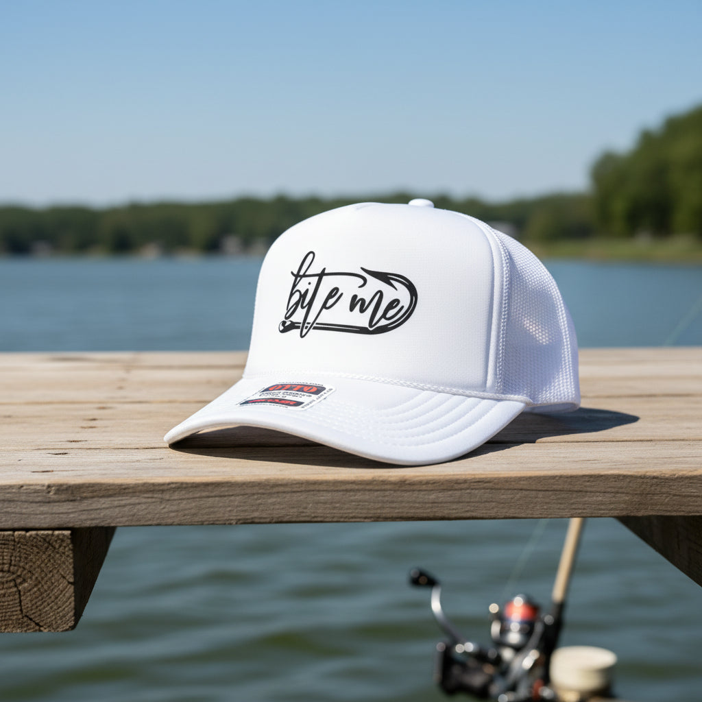 A white trucker hat with a black 'bite me' graphic on the front
