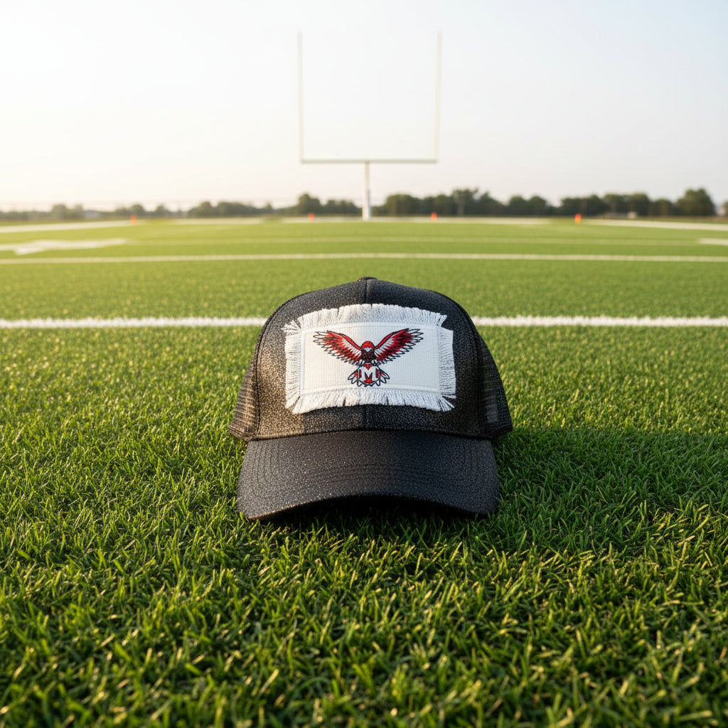 A black glittery trucker hat with a white patch featuring a red and black eagle logo.