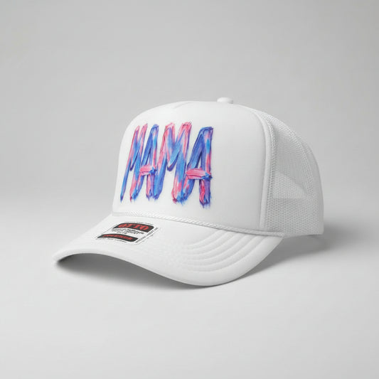 A white trucker hat with a colorful 'MAMA' graphic on the front panel, featuring blue and pink paint-stroke lettering. The brim has a visible 'OTTO' brand sticker.