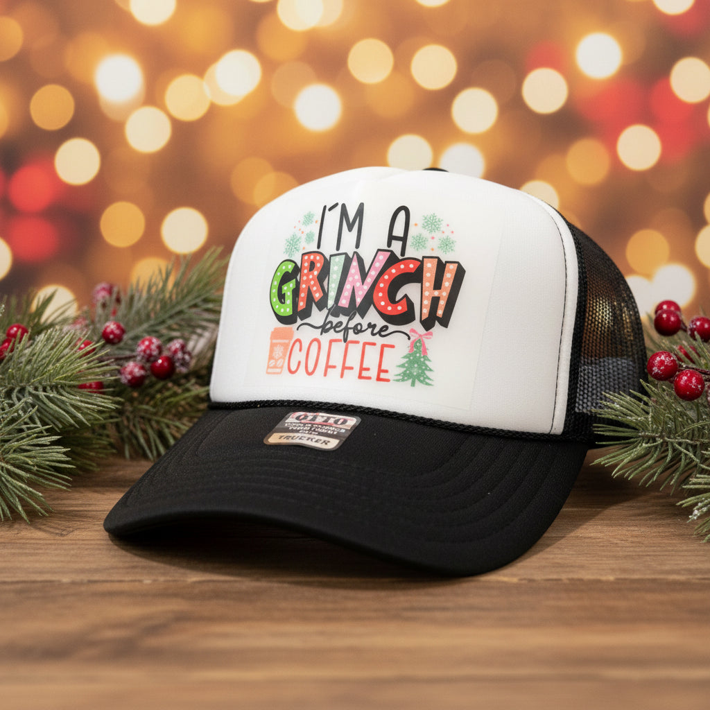 A black and white trucker hat with a festive graphic that reads 'I'M A CRUNCH before COFFEE' in holiday colors, resting on a rustic wooden surface.