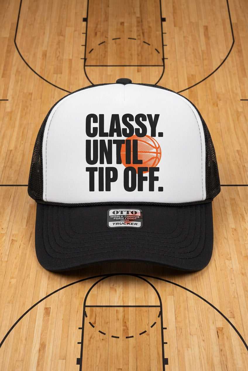 A black and white trucker hat with a white front panel featuring the text 'CLASSY. UNTIL TIP OFF.