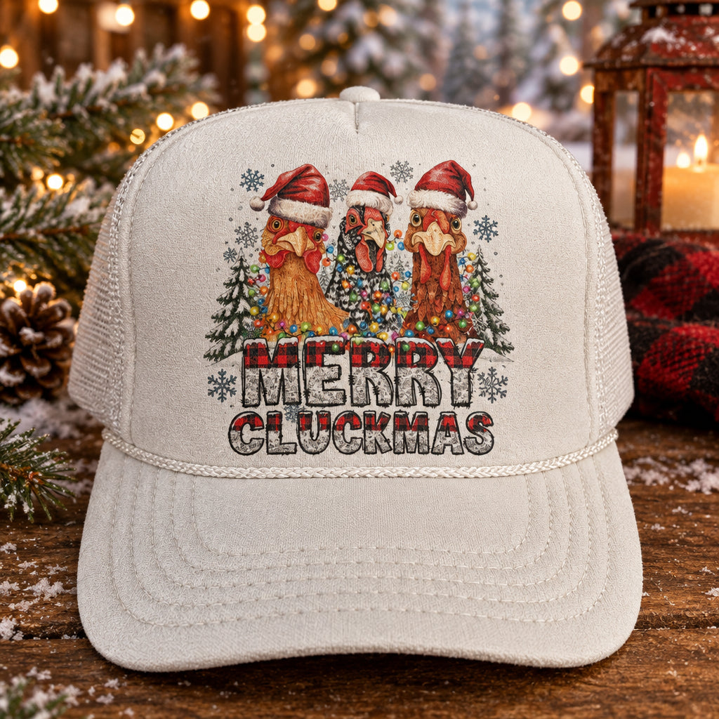 A white trucker hat with a colorful 'Merry Merry Ouchmas' graphic on the front, resting on a dark wooden surface.