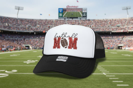A black and white trucker hat with a 'football MOM' graphic on the front panel.