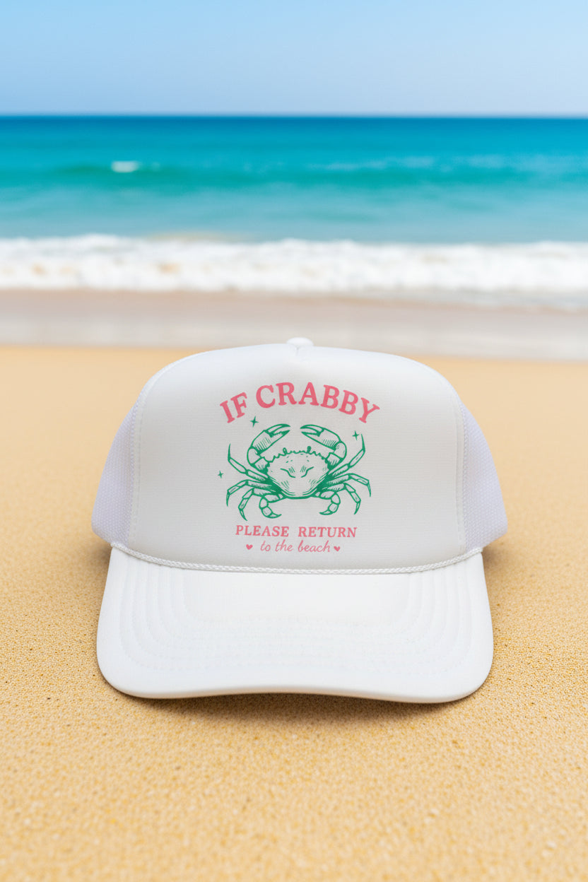 A white foam trucker hat with a printed graphic on the front panel featuring a green crab and the text 'IF CRABBY PLEASE RETURN to the beach' in red. The brim has a visible 'OTTO World Famous Foam Front Trucker' patch.