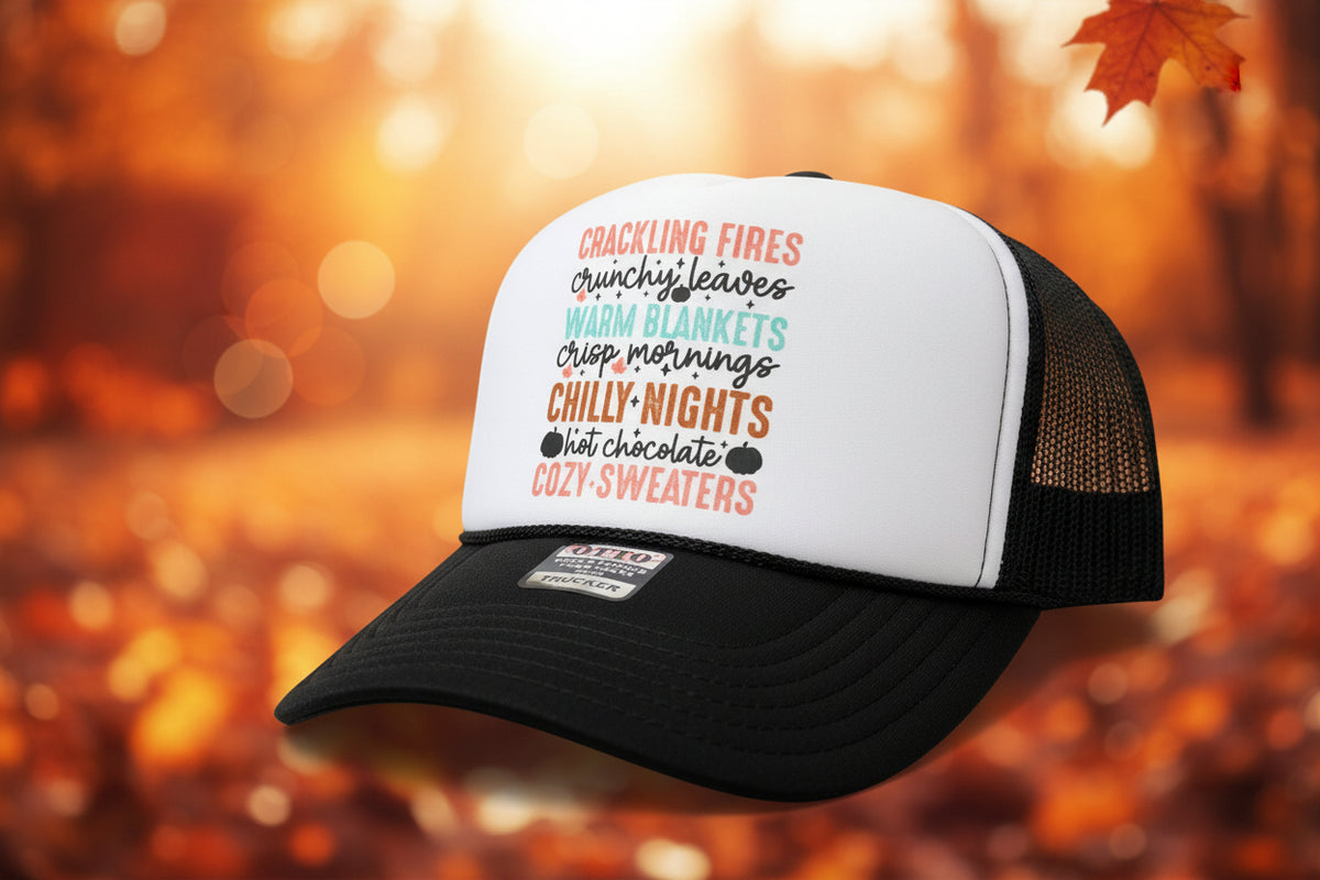 A black and white trucker hat with a custom printed text graphic on the front panel, resting on a wooden table.