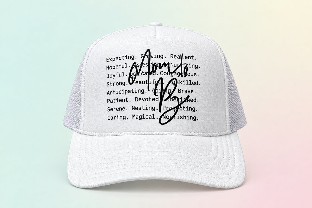 A white trucker-style baseball cap with black printed text on the front and a large black autograph across the center. The brim also has an Otto Trucker label.
