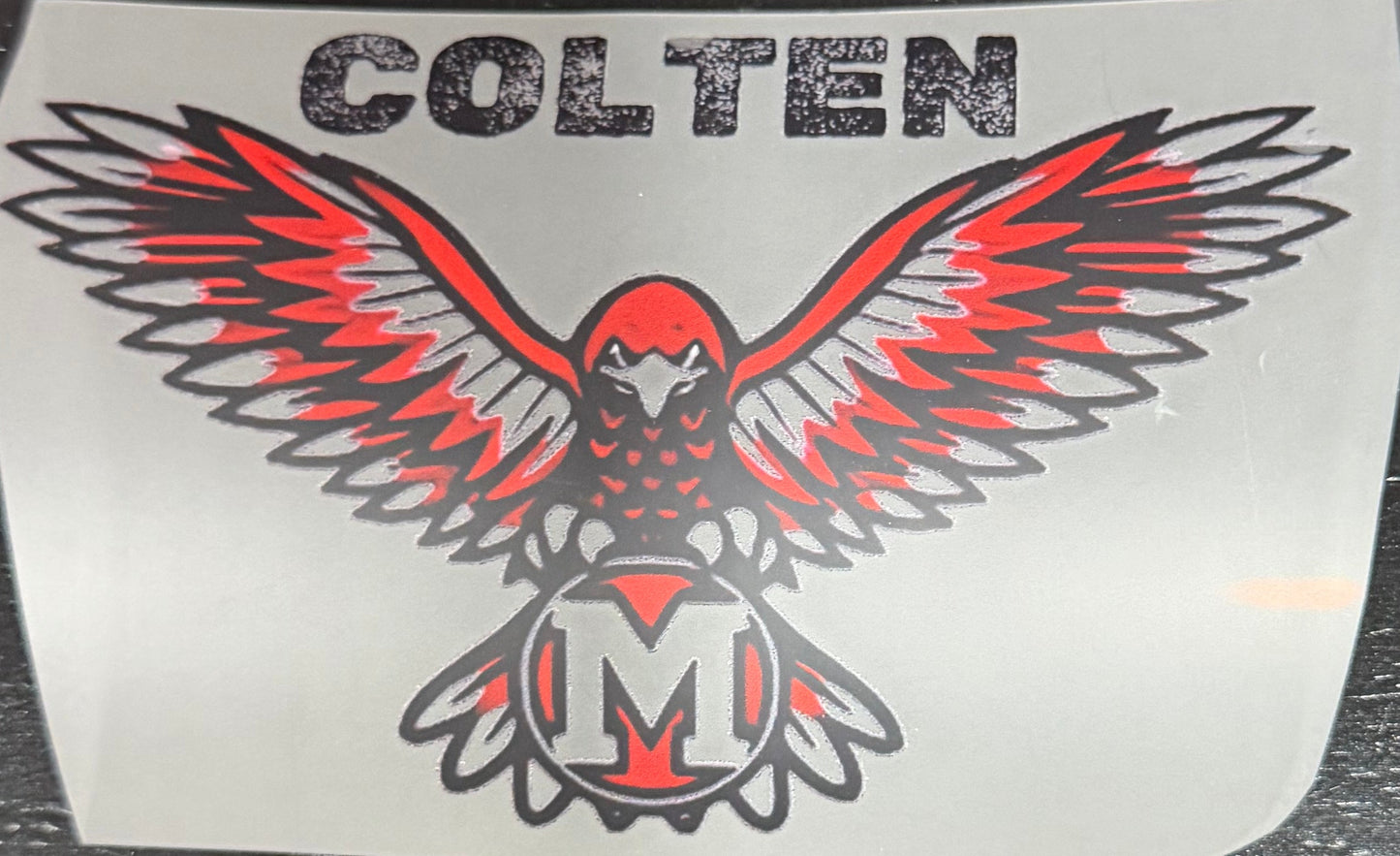 A close-up of a DTF print featuring a red and black red hawk decal with customized name.