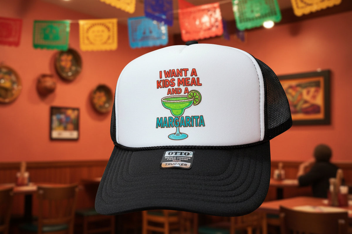 A black and white trucker hat with a custom graphic sticker on the front. The sticker features the text 'I WANT A KIDS MEAL AND A MARGARITA' in red and blue lettering, surrounding an illustration of a green margarita cocktail with a lime wedge.
