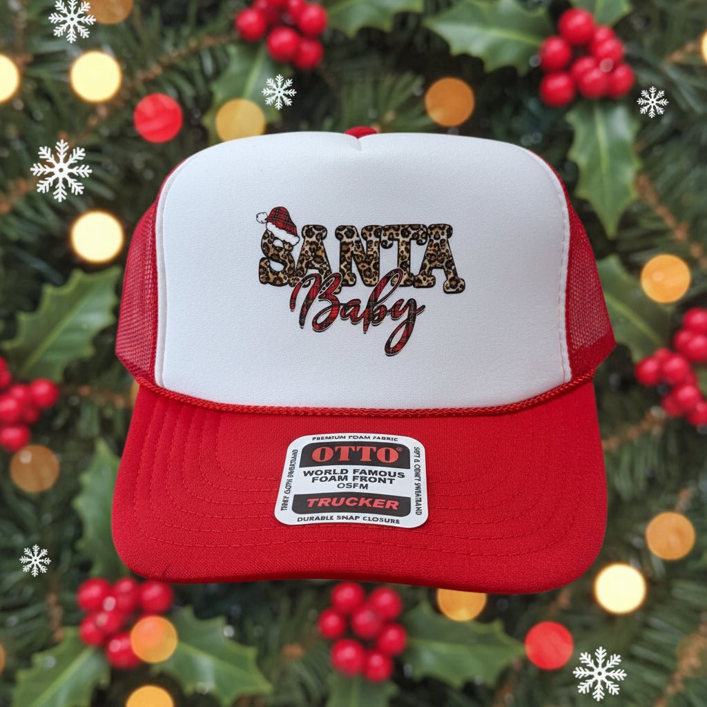 A red and white trucker hat with 'Santa Baby' written on the front in leopard print and red script