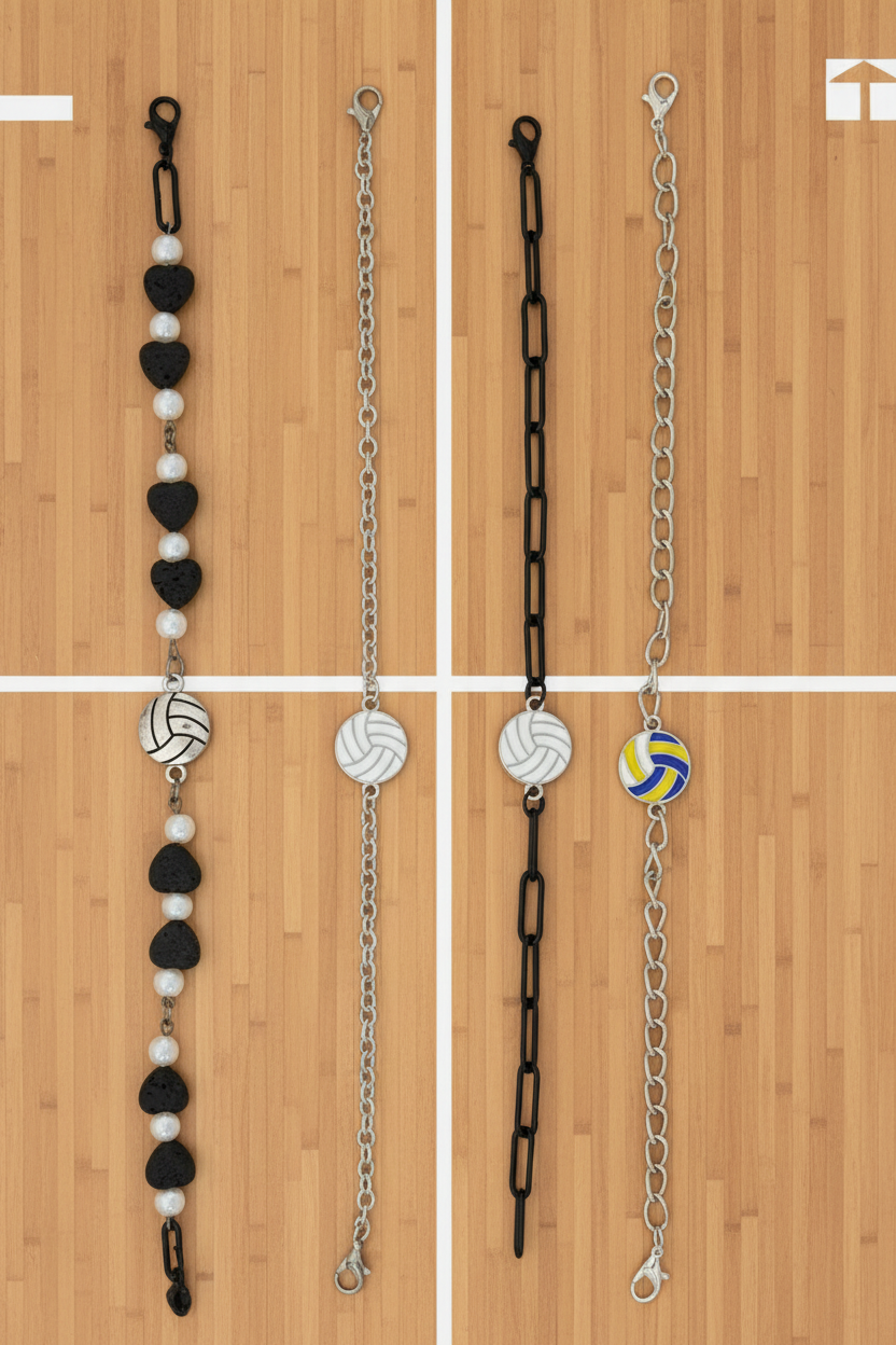 Four beaded and chain bracelets laid flat on a dark wood background. Three bracelets feature black and white beads with silver-toned links, and one bracelet features a yellow and blue volleyball charm on a silver chain.