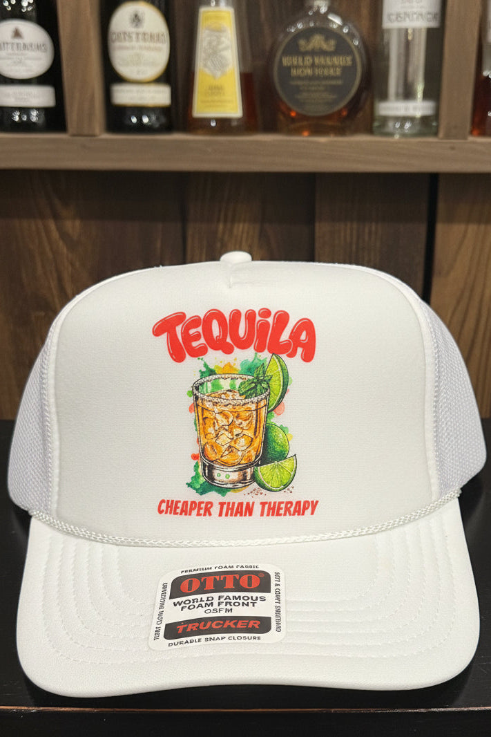 A white trucker-style baseball cap with a front graphic that reads 'TEQUILA' in red and 'CHEAPER THAN THERAPY' below an illustration of a tequila cocktail with lime slices. The cap has mesh side/back panels and a visible Otto Trucker sticker on the brim.