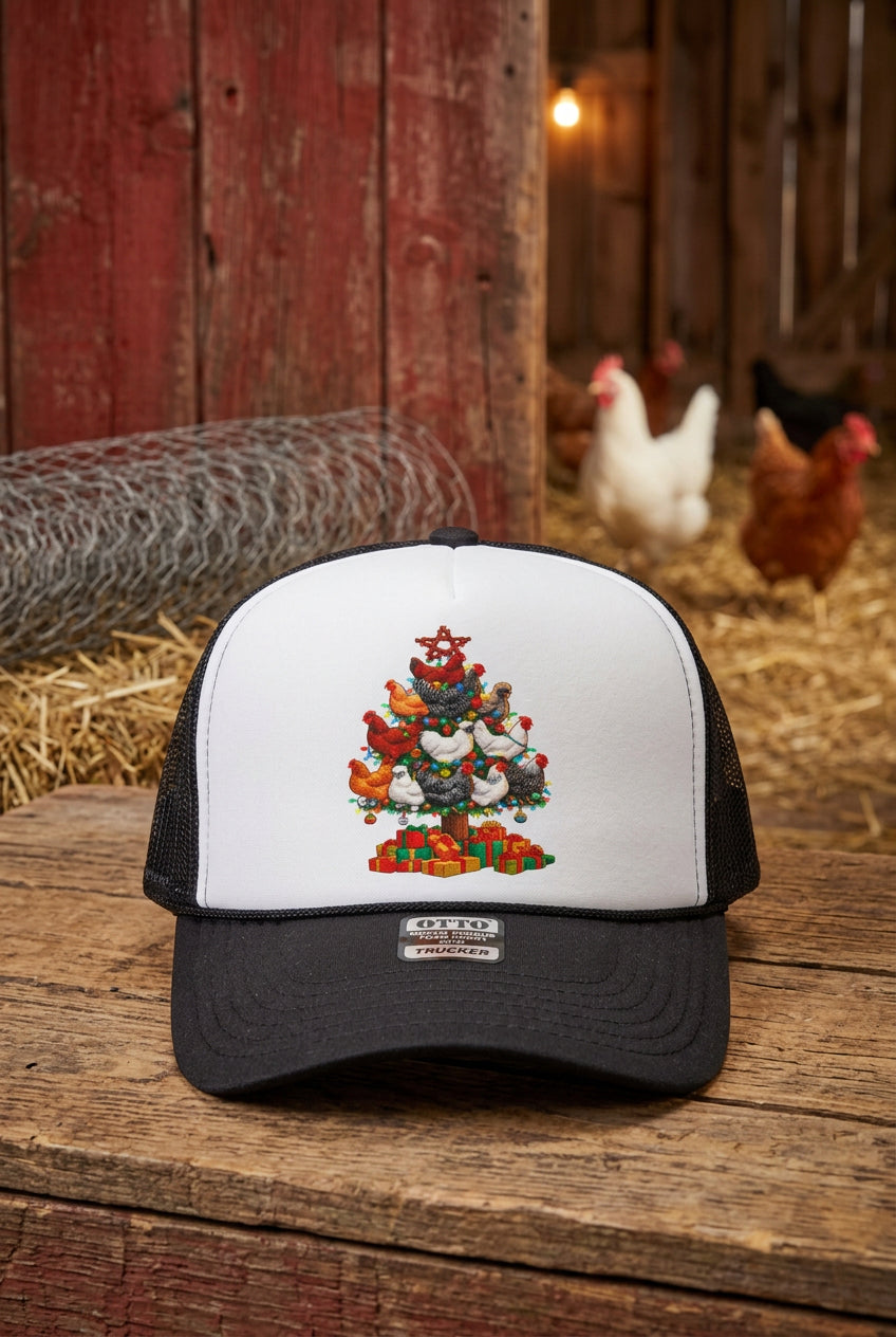 A black and white trucker hat with a colorful Christmas tree made of chickens and turkeys printed on the front, displayed on a wooden surface.