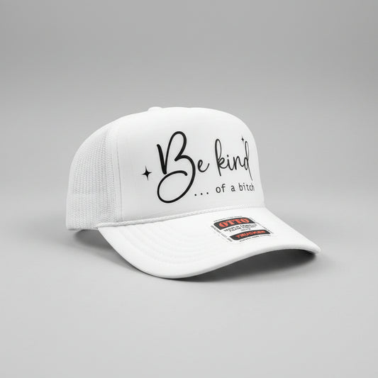 A white trucker hat with black script text reading 'Be kind .