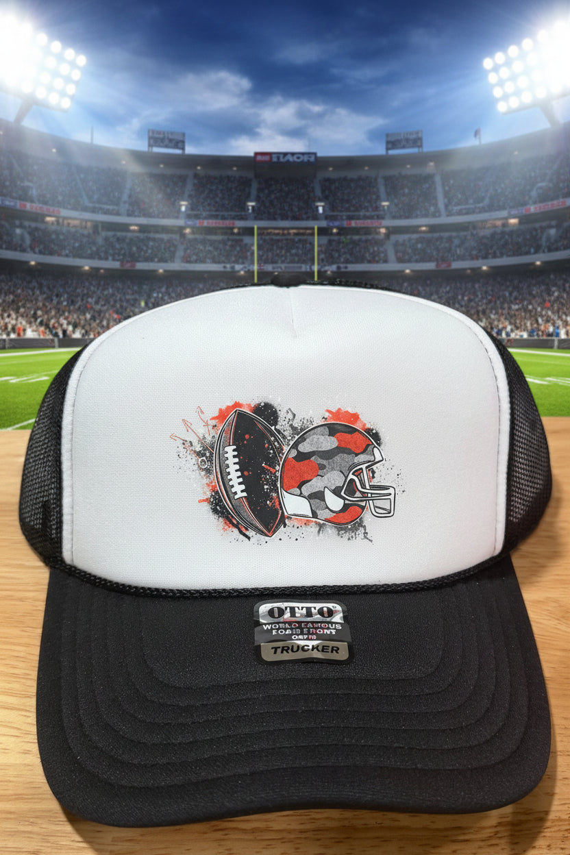 A black and white trucker hat with a graphic of a football and helmet on the front panel.