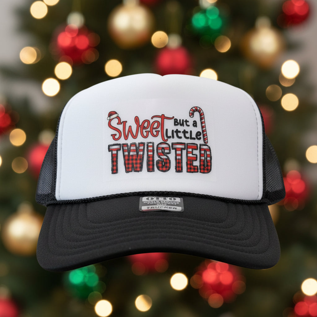 A black and white trucker hat with a custom graphic on the front panel reading 'Sweet like a little TWISTED' in red and black.